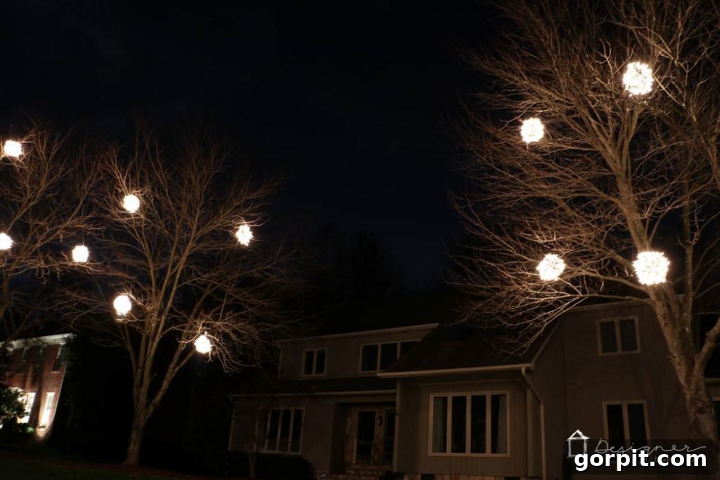 Christmas lights tutorial: See the finished lighted balls illuminating the night. Perfect outdoor holiday decoration ideas.