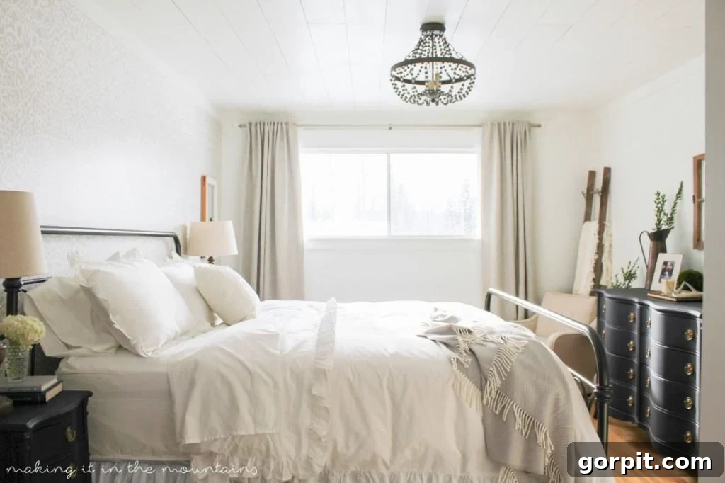 Serene farmhouse style master bedroom makeover by Making it in the Mountains, showcasing clean lines, cozy textures, and timeless charm.