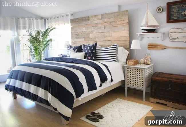 Tasteful nautical master bedroom makeover featuring a stunning reclaimed wood DIY headboard by The Thinking Closet, perfect for a serene coastal vibe.