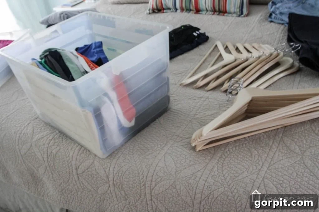 All closet contents piled on the bed and floor, ready for sorting and decluttering. 