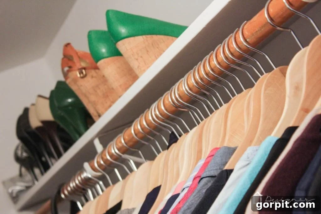 A closer view of the organized closet, highlighting uniform hangers and clear categorization. 
