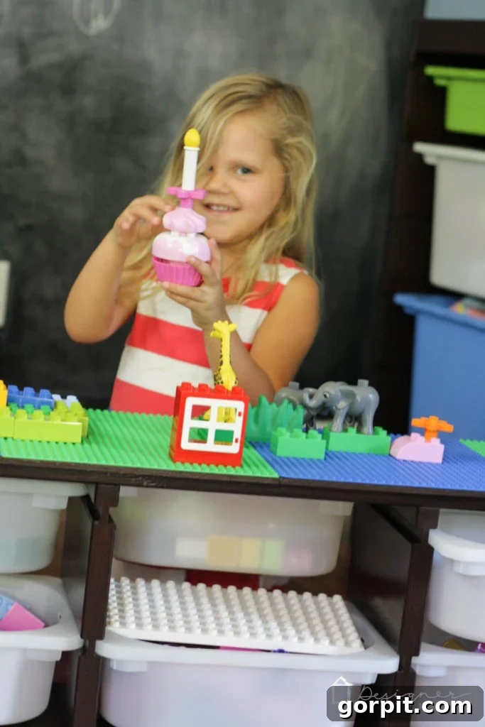 Full view of the DIY Lego table in a child's playroom, showcasing its integration with other toy storage solutions.