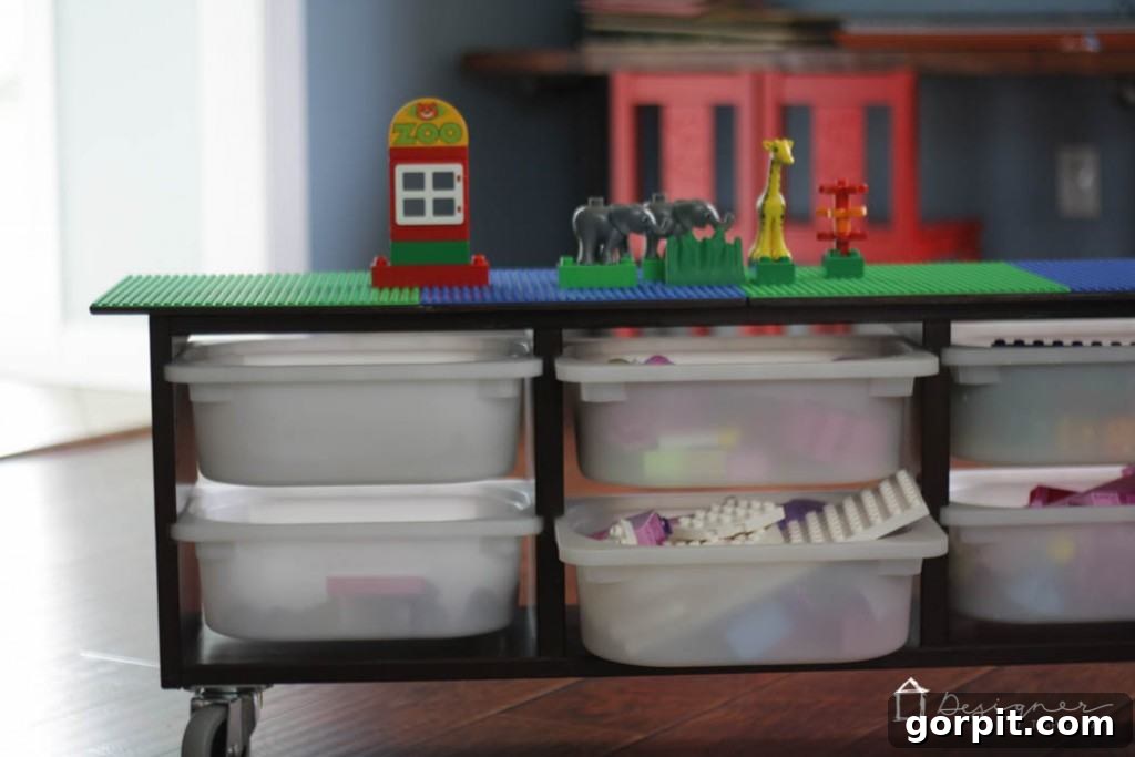 A child's hands busy building on the DIY Lego table, illustrating the dedicated and functional play surface.