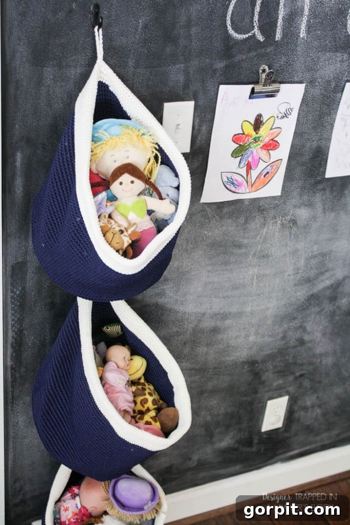 Creative and simple DIY hanging toy storage using baskets mounted on a wall, perfect for small spaces and easy access.