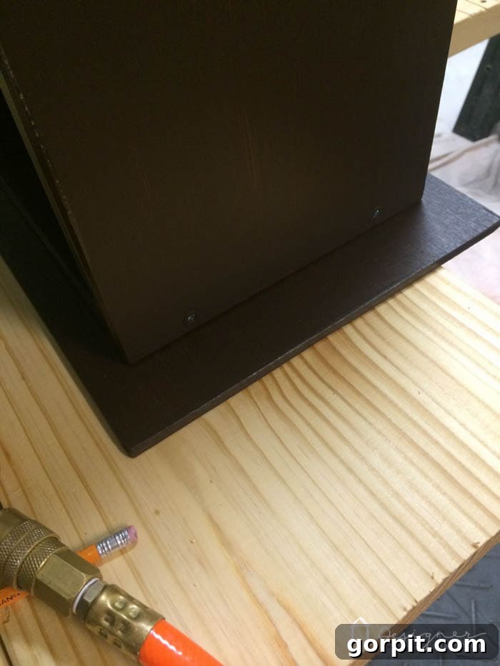 Underside view of the plywood tabletop showing the stained overhang, emphasizing the importance of staining the bottom surface.