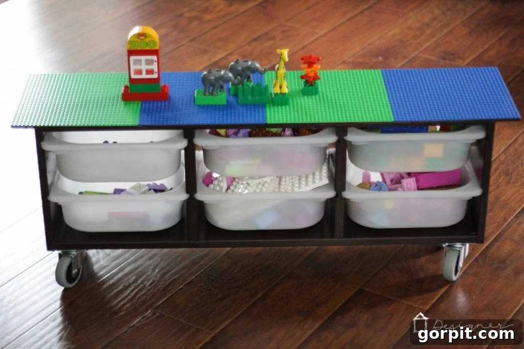 Close-up view of the DIY Lego table, highlighting the securely glued Lego base plates and the rich mahogany stain of the Trofast unit.