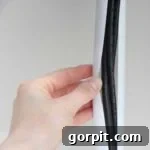 Creative hack to hide wire clutter using a shower rod.