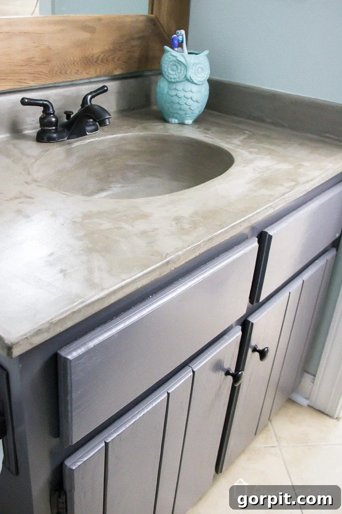 After: Transformed bathroom vanity with a DIY concrete overlay using Ardex Feather Finish, a budget-friendly renovation.