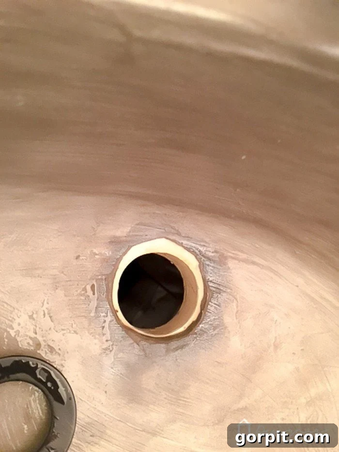 Step 2: Removing the drain and breaking away concrete from underneath the drain area.