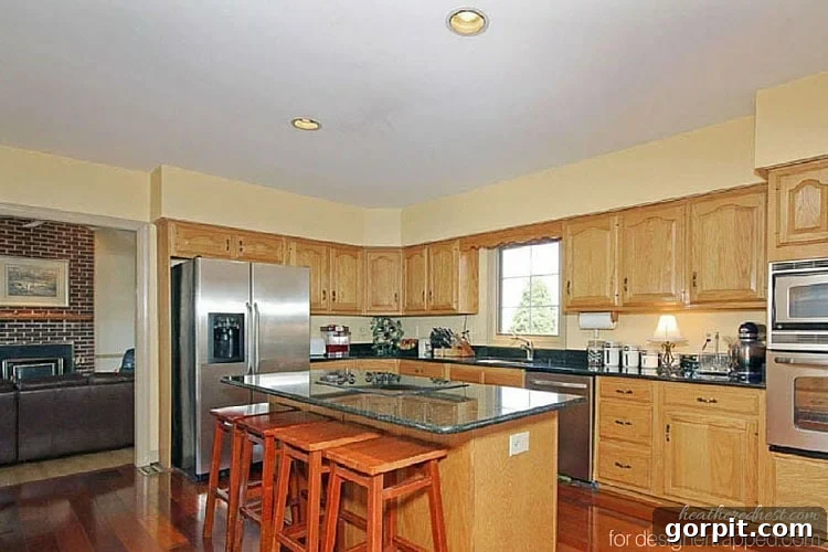 Out with the old: Transforming a kitchen with sterile recessed lighting into a warm space with stylish pendant lights.