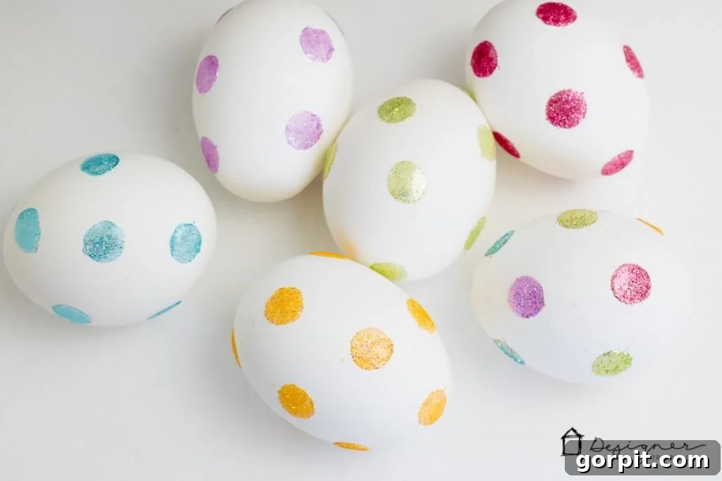 A collection of beautifully decorated glitter dotted Easter eggs, ready for display.