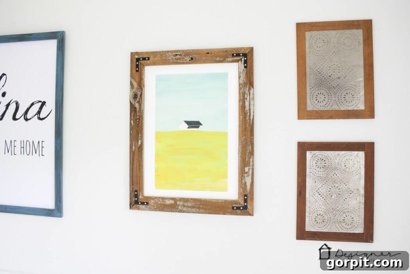 Gallery wall featuring multiple DIY reclaimed wood picture frames in a dining room setting.