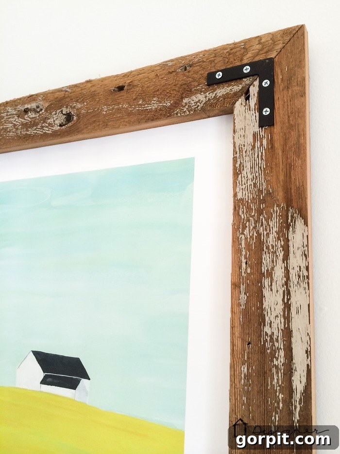 Detailed shot of the corner of a DIY reclaimed wood frame with industrial hardware.