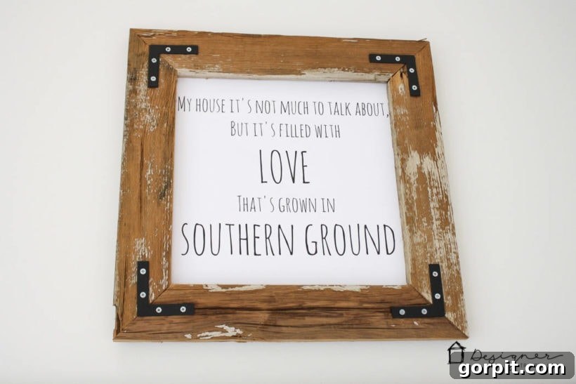 Another view of a finished DIY reclaimed wood frame showcasing the art.