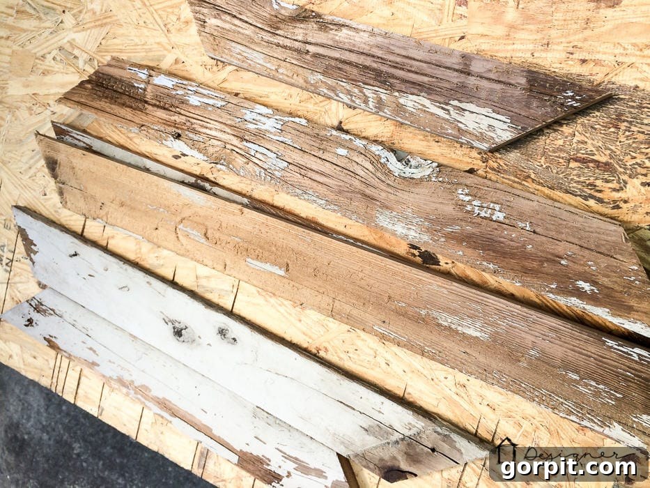 Reclaimed wood being cut with a miter saw at a 45-degree angle for a DIY picture frame.
