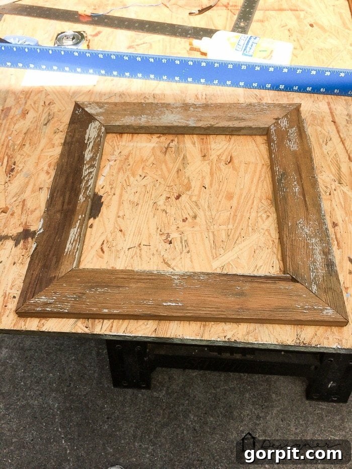 Assembling a DIY picture frame using reclaimed wood and flat corner braces.