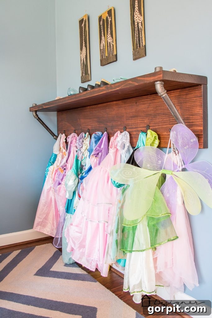 Close-up of DIY pipe shelves and built-in desks in the kids' playroom, demonstrating smart playroom storage ideas and a dedicated learning zone.