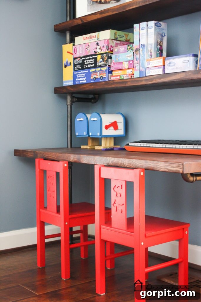 A cozy reading nook in the kids' playroom with a comfortable loveseat and charming wall art, demonstrating thoughtful playroom decor for relaxation.