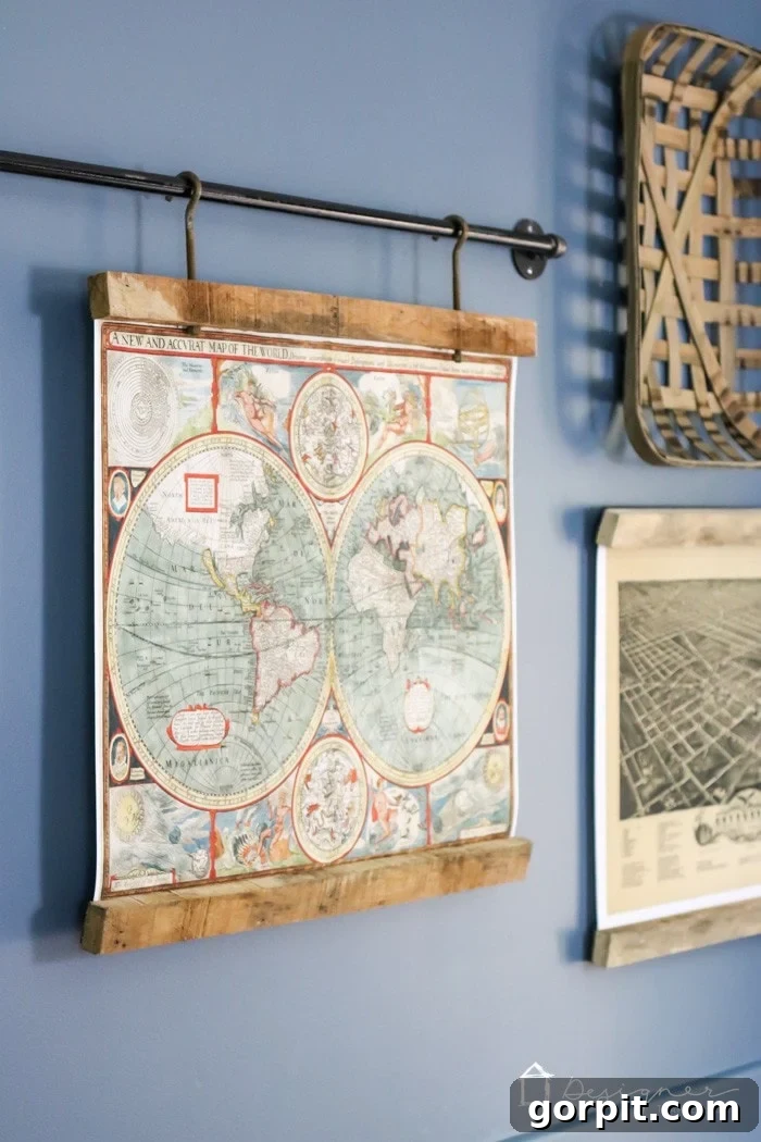 Close-up of a DIY reclaimed wood picture frame holding a vintage map, suspended from an industrial metal pipe, highlighting the rustic aesthetic.
