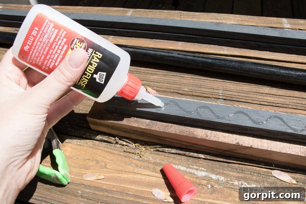 Close-up of wood pieces being precisely glued together with DAP Rapid Fuse Wood Adhesive and firmly clamped, illustrating the strong bond forming on reclaimed wood surfaces.