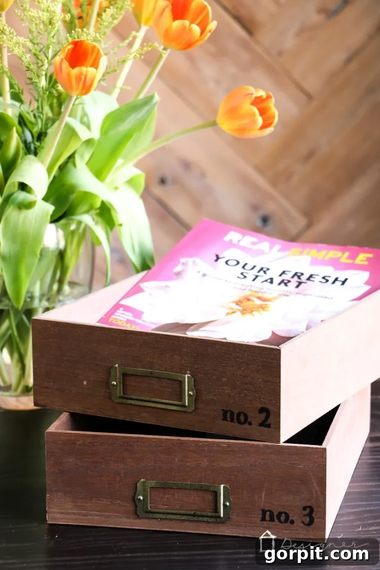 Close-up of a DIY desk organizer tray with 'No. 1' label, filled with neatly sorted documents