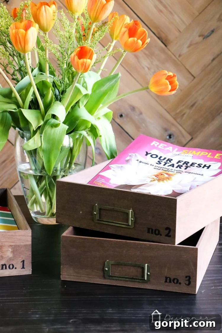 Perspective view of multiple DIY stacked desk organizer trays on a clean office desk