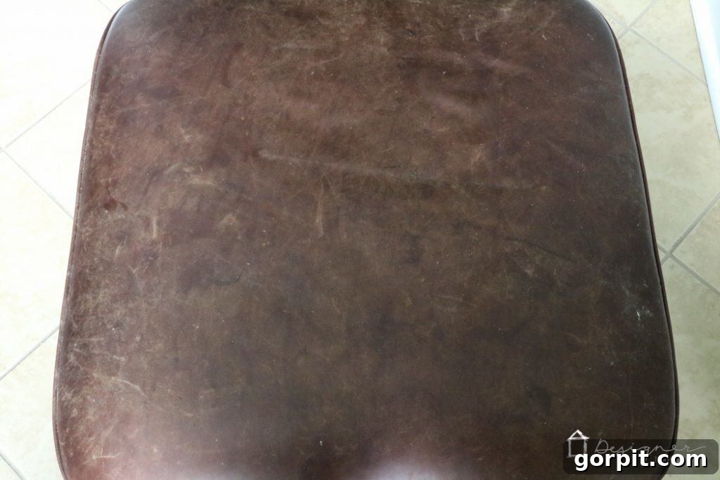 Breathe New Life into Your Leather Furniture 5 Severely damaged leather ottoman before restoration