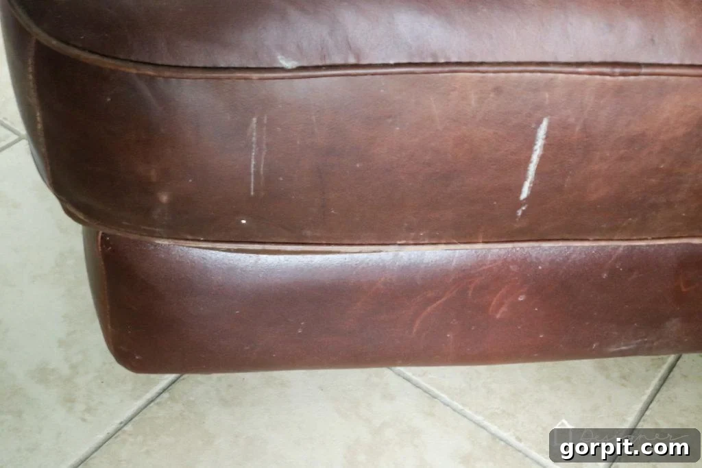 Breathe New Life into Your Leather Furniture 7 Close-up of damaged leather surface before restoration showing deep marks