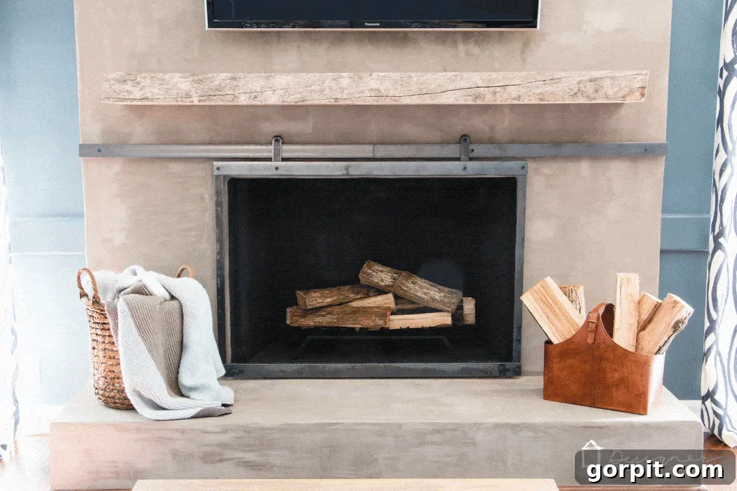 Finished barn door style sliding fireplace screen in a beautifully decorated living room.