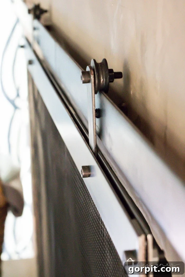 Side view of the sliding barn door fireplace screen in an interior setting.
