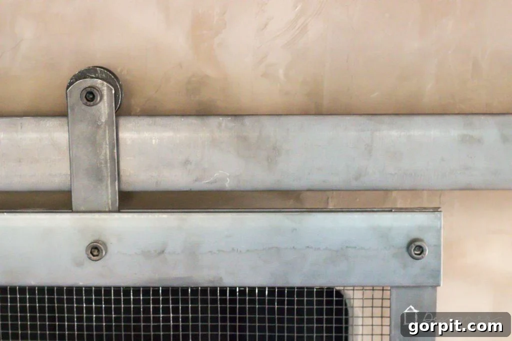 Front view of the barn door fireplace screen, highlighting its industrial-chic design.