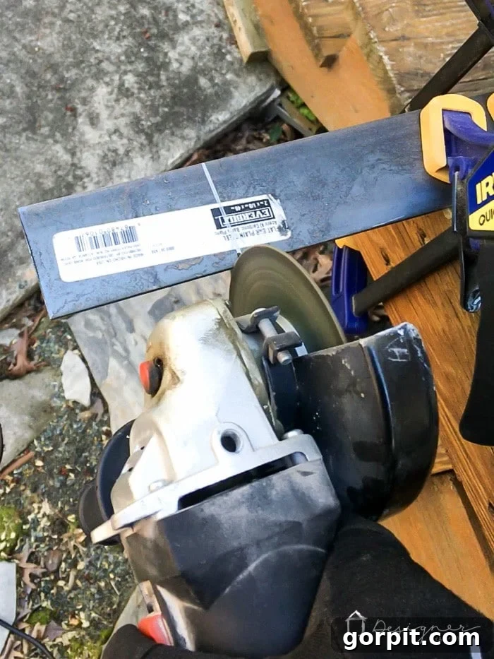 Cutting the steel bars for the fireplace screen frame to size with an angle grinder.