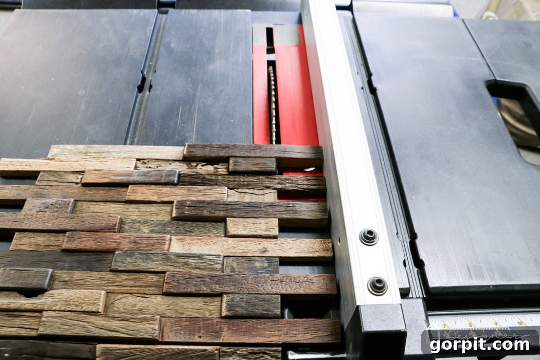 IKEA Lack Transformation: Designer Style for Less 7 A person carefully using a table saw to trim the edge of a wood mosaic tile sheet, preparing it to fit flush within the IKEA Lack table's shelf.