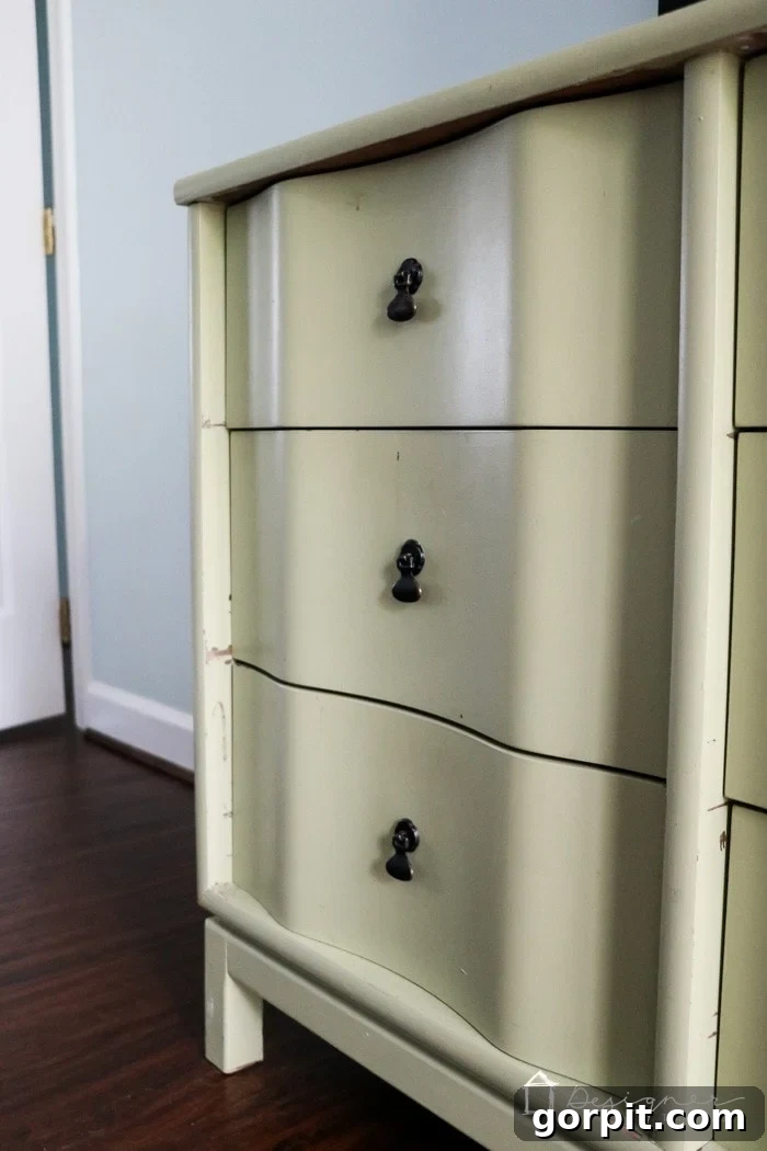 Wood Wonders: Your Guide to Transforming Furniture with Paint 3 A close-up of chipping latex paint on a three drawer vintage dresser. Learning how to paint wooden furniture will prevent paint from looking dirty and tattered later on.