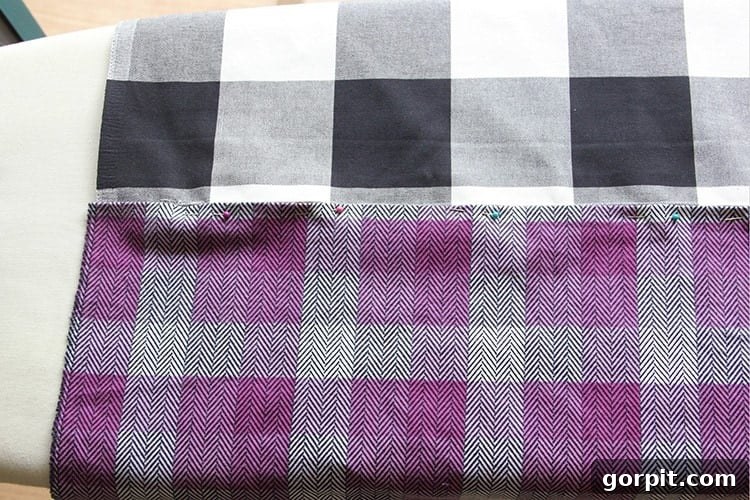 Sew Your Own Zippered Pillow Cover 11 A zipper is pinned to the second fabric piece, demonstrating the careful alignment required before sewing the final side of the zipper.