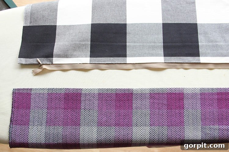 Sew Your Own Zippered Pillow Cover 10 An overhead shot showing two fabric pieces, right sides up, with one side of a zipper already sewn to the first piece of fabric.