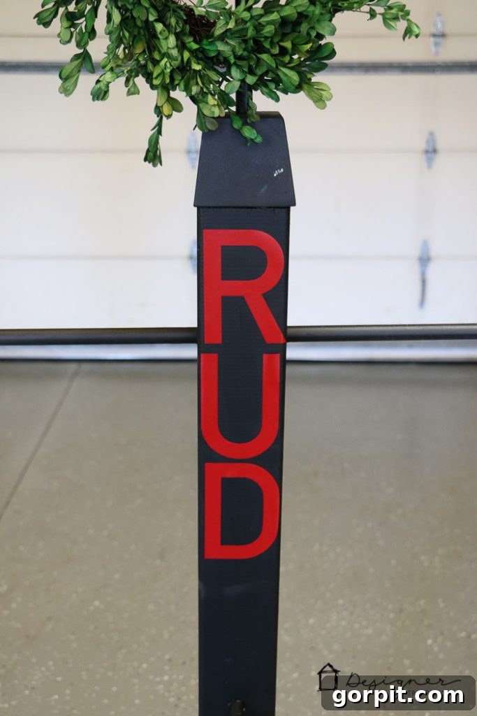 Decorating the DIY stocking stand with reindeer names in vinyl