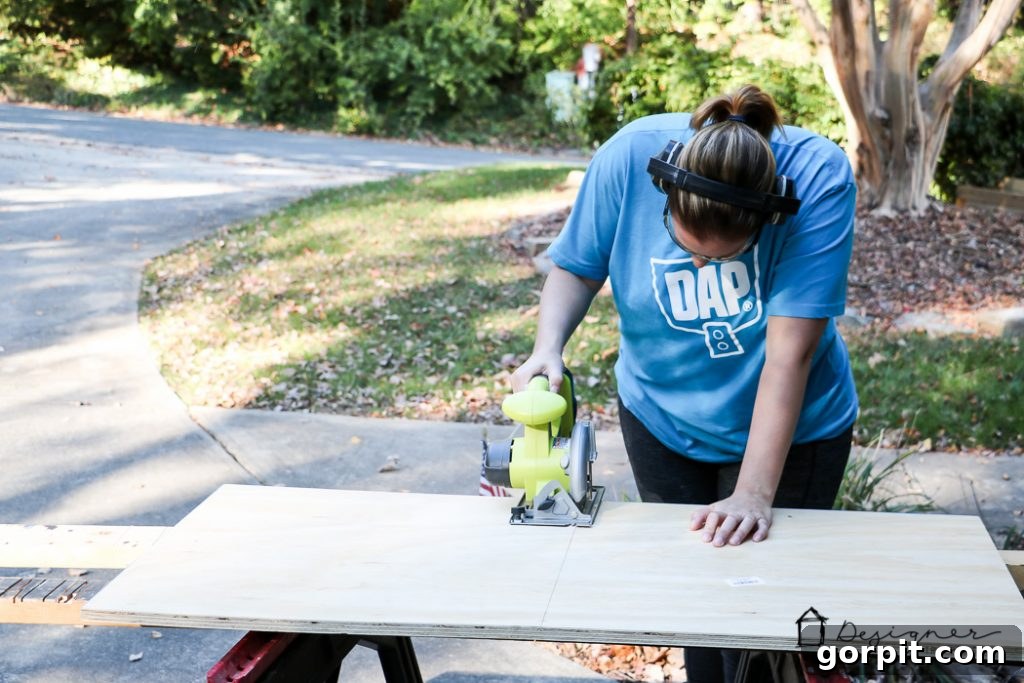 Using a circular saw to precisely cut the plywood base for the stocking stand