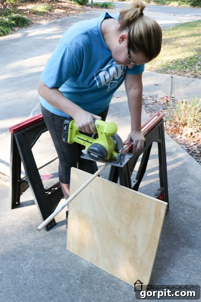 Cutting the wooden dowel in half for the stocking holder arms