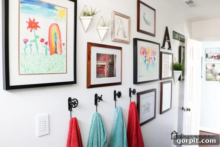 A vibrant gallery wall in a DIY bathroom, featuring children's art and geometric wall vases.
