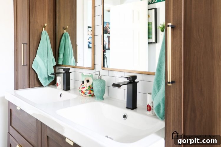 A wide shot showcasing the cohesive design of the DIY bathroom, highlighting tile work and vanity.