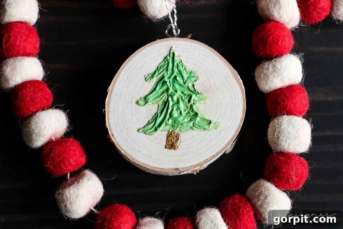 The handmade textured Christmas tree ornament hanging beautifully, ready to adorn a holiday display or Christmas tree.