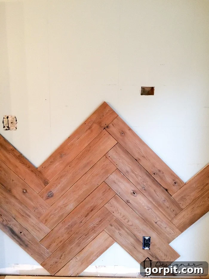 Transforming an Old Fence into a DIY Herringbone Wall 8 in process herringbone wall