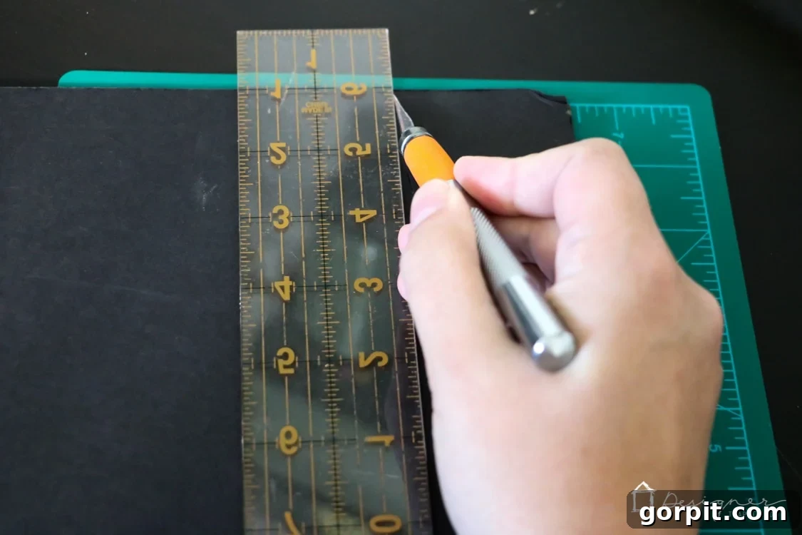 Craft knife cutting foam board for DIY project