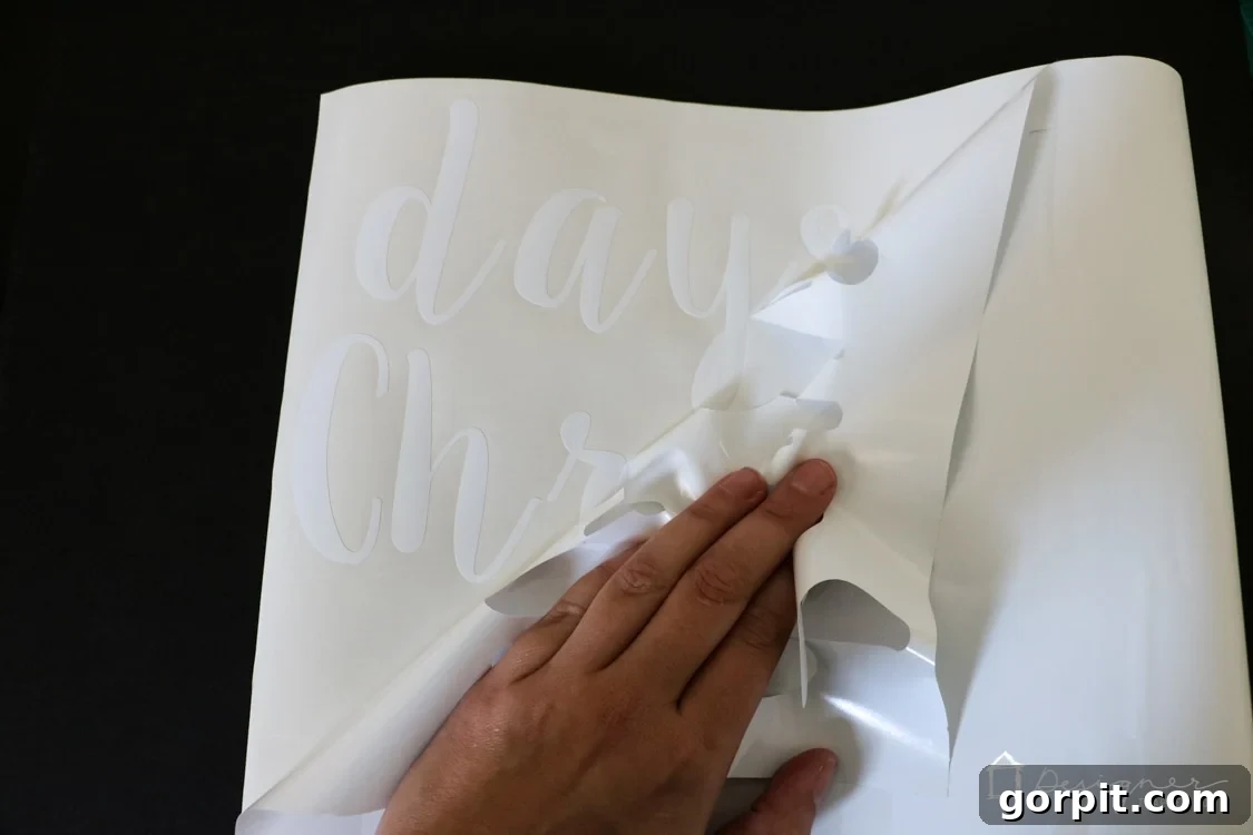 Process of weeding excess vinyl from a cut design