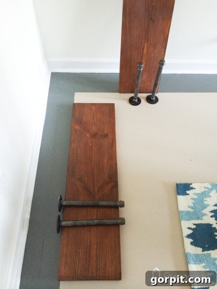 Easy Pipe Shelf Building Guide 4 Installing DIY pipe shelves, close-up on bracket assembly