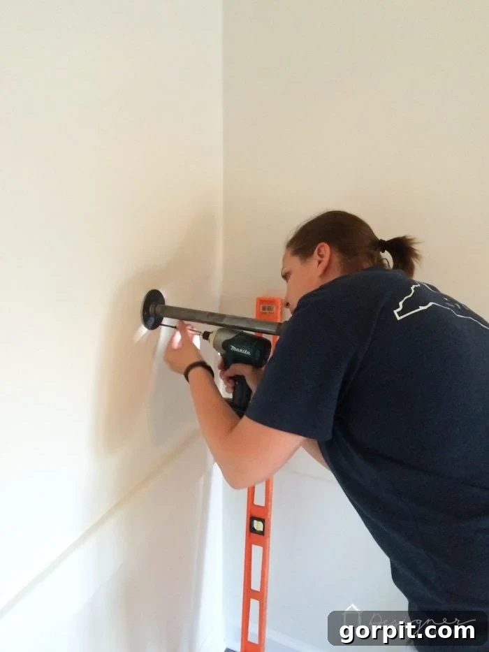 Easy Pipe Shelf Building Guide 5 Securing industrial pipe shelf brackets to the wall