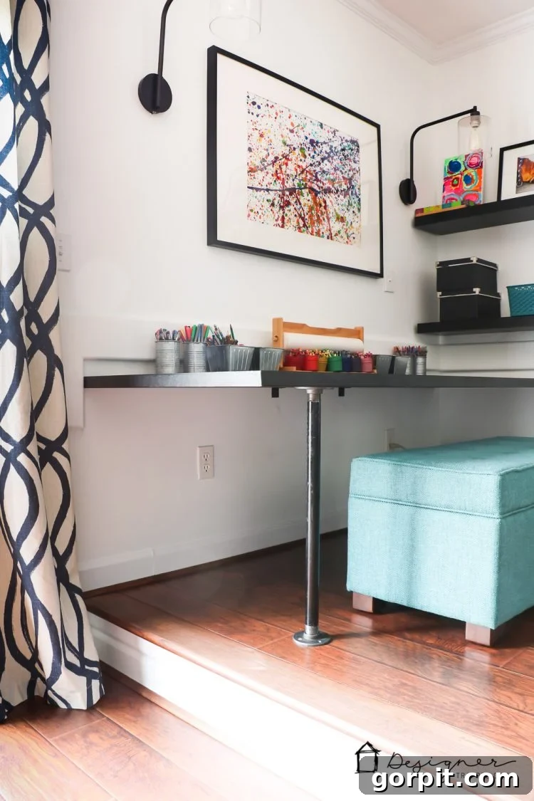 Effortless Pipe Desk DIY 15 The spacious DIY pipe desk featuring a large coloring book and supplies, highlighting its use as an art and activity table.