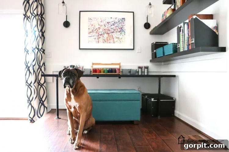 Effortless Pipe Desk DIY 17 A loyal dog, Titan, playfully photo-bombing a shot of the new DIY industrial pipe desk in the playroom.