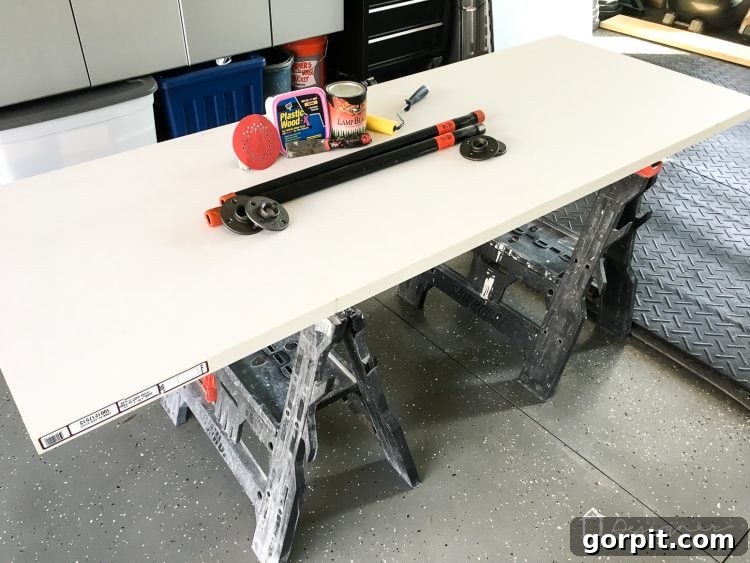 Effortless Pipe Desk DIY 3 DIY pipe desk tutorial step one: Applying wood filler to the rough edges of a hollow core door, preparing it for a smooth finish.